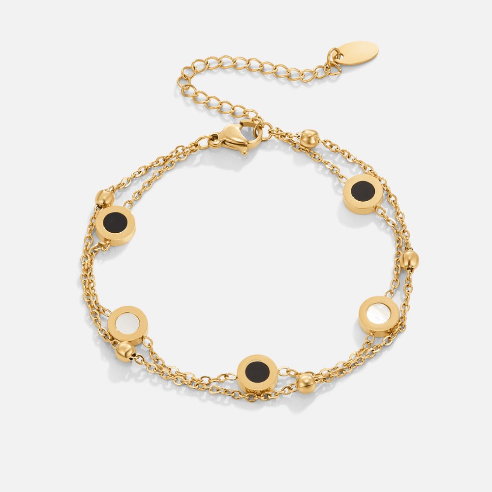 Carla – Pulsera de oro suave con elementos redondos contrastantes.