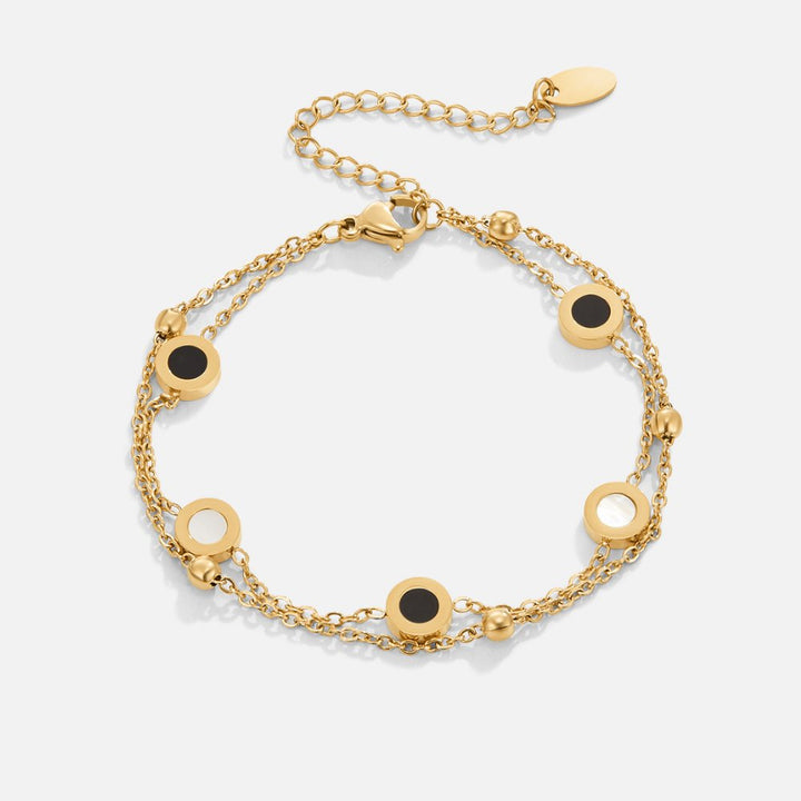 Carla – Pulsera de oro suave con elementos redondos contrastantes.